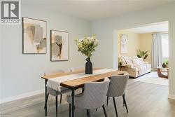 Dining room featuring light wood-type flooring and baseboards - 