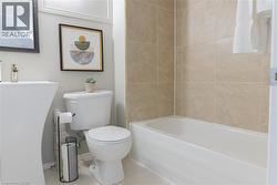 Full bathroom with tile patterned floors and bathing tub / shower combination - 