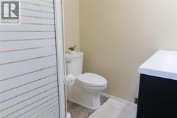 Half bathroom with vanity and light wood finished floors - 
