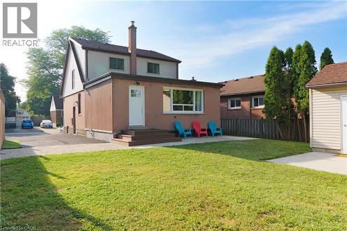 Rear view of property with a patio, a chimney, and brick siding - 39 Cloverhill Road, Hamilton, ON - Outdoor With Exterior