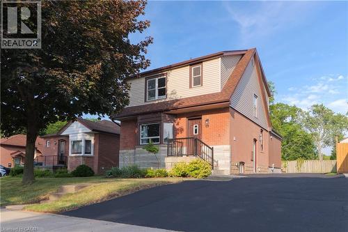 View of front of home with a shingled roof and brick siding - 39 Cloverhill Road, Hamilton, ON - Outdoor