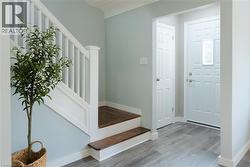 Foyer entrance with stairs and light wood finished floors - 