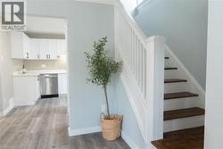 Stairway featuring baseboards and wood finished floors - 
