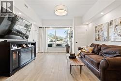 Living room featuring light wood-style floors and recessed lighting - 