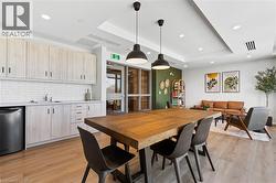 Dining room with a tray ceiling, recessed lighting, and light wood-style flooring - 