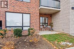 Entrance to property with brick siding and a patio area - 