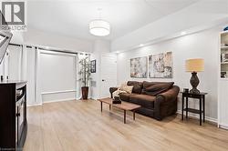 Living area featuring light wood-style floors and recessed lighting - 