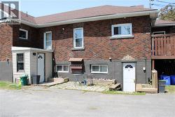 View of front of home with brick siding and a shingled roof - 
