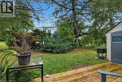 View of green lawn featuring a deck - 