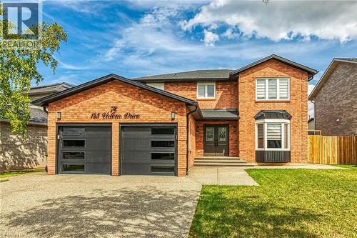 View of front of house featuring brick siding, driveway, a front lawn, and an attached garage - 125 Valera Drive, Hamilton, ON 
