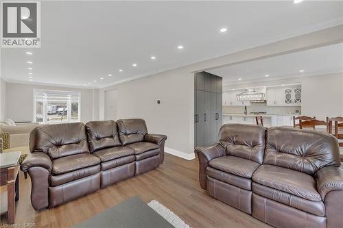 Living room with ornamental molding, light wood-style flooring, and recessed lighting - 125 Valera Drive, Hamilton, ON 