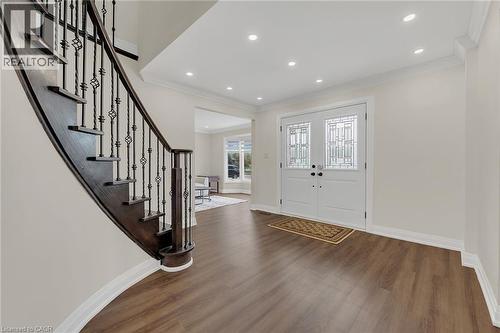 Entryway featuring wood finished floors, stairs, crown molding, and recessed lighting - 125 Valera Drive, Hamilton, ON 