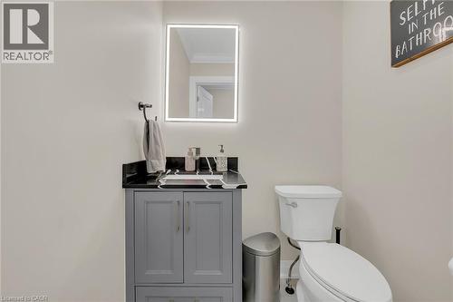 Half bath featuring vanity and ornamental molding - 125 Valera Drive, Hamilton, ON 