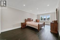 Bedroom featuring crown molding, recessed lighting, and dark wood-type flooring - 