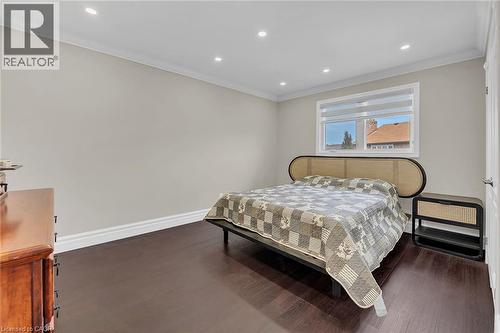 Bedroom featuring ornamental molding, recessed lighting, and dark wood finished floors - 125 Valera Drive, Hamilton, ON 