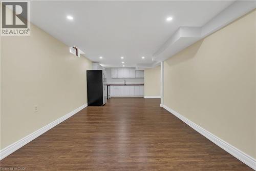 Unfurnished living room featuring dark wood-type flooring and recessed lighting - 125 Valera Drive, Hamilton, ON 