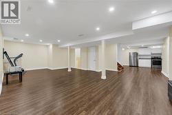 Workout area featuring recessed lighting and dark wood finished floors - 