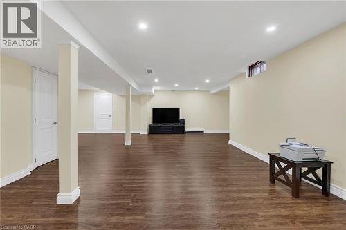 Finished basement with dark wood-style floors and recessed lighting - 125 Valera Drive, Hamilton, ON 