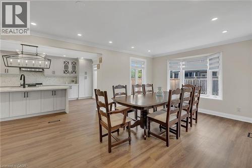 Dining room with crown molding, recessed lighting, and light wood-style flooring - 125 Valera Drive, Hamilton, ON 