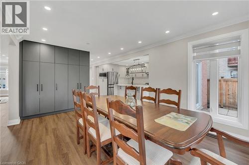 Dining area with plenty of natural light, light wood finished floors, ornamental molding, and recessed lighting - 125 Valera Drive, Hamilton, ON 