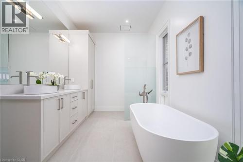 Bathroom featuring a soaking tub, double vanity, recessed lighting, and light tile patterned flooring - 1322 Minaki Road, Mississauga, ON - Indoor Photo Showing Bathroom
