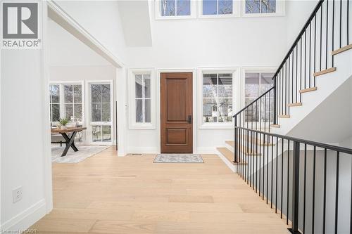 Foyer with a high ceiling, light wood finished floors, and stairs - 1322 Minaki Road, Mississauga, ON - Indoor Photo Showing Other Room