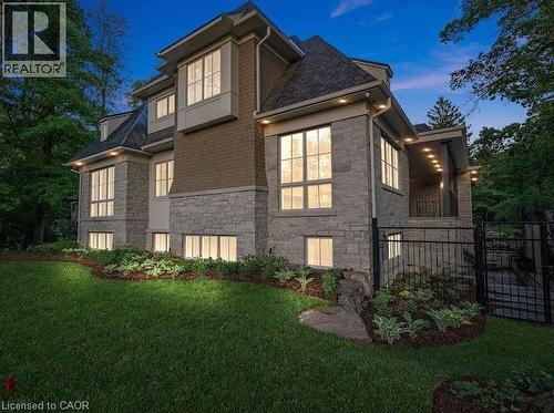 View of side of home with stone siding and a balcony - 1322 Minaki Road, Mississauga, ON - Outdoor