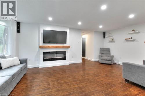 Living area with recessed lighting, an electric fireplace, and dark wood flooring - 35 Green Valley Drive Unit# 103, Kitchener, ON - Indoor With Fireplace