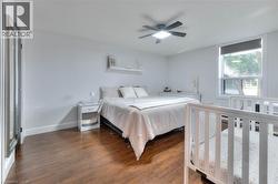 Master Bedroom featuring dark wood flooring and a ceiling fan - 