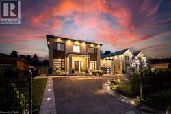 Modern home with driveway, a patio, and brick siding - 