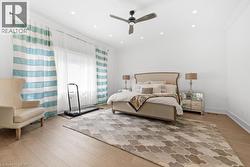 Bedroom featuring ornamental molding, light wood finished floors, ceiling fan, and recessed lighting - 