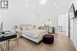 Bedroom with ornamental molding, light wood-style flooring, recessed lighting, and a desk - 
