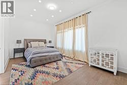 Bedroom with ornamental molding, wood finished floors, and recessed lighting - 