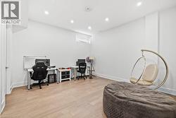 Office area with light wood finished floors and recessed lighting - 