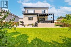 Back of property with a patio, stucco siding, and stairs - 