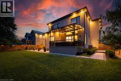 Back of house with stucco siding, a patio, a balcony, and a deck - 