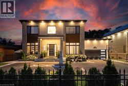 Contemporary home featuring concrete driveway and stucco siding - 