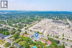 Aerial view of property and surrounding area with a tree filled landscape - 