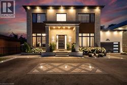 Modern home featuring driveway, a patio area, and an attached garage - 