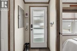 Doorway to outside featuring ornamental molding - 