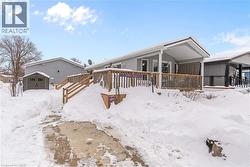 Snow covered house with a storage shed - 