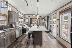 Kitchen featuring Vaulted ceiling, a center island, pendant lighting - 