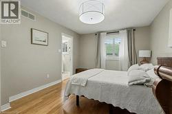 Bedroom with light wood-style floors and a textured ceiling - 