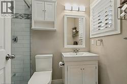 Bathroom featuring tiled shower and vanity - 