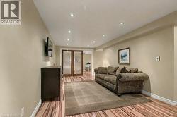 Living area featuring recessed lighting, light wood-style flooring, and french doors - 