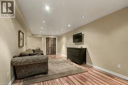 Living area featuring light wood finished floors and recessed lighting - 