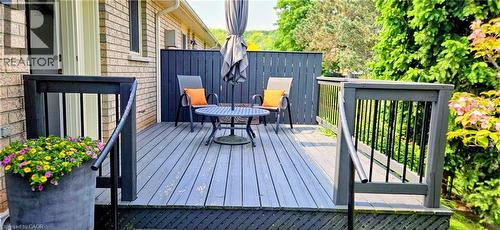 Gray-toned wooden deck featuring black railings and a privacy screen - 165 Main Street E Unit# 9, Grimsby, ON - Outdoor With Deck Patio Veranda With Exterior