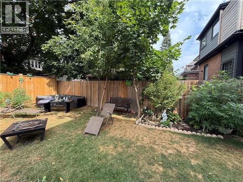 Fenced backyard with an outdoor fire pit - 106 Spadina Avenue Unit# 1, Hamilton, ON - Outdoor