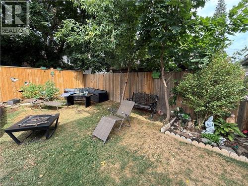 Fenced backyard with an outdoor hangout area - 106 Spadina Avenue Unit# 1, Hamilton, ON - Outdoor