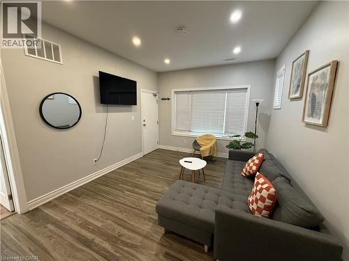 Living area featuring wood finished floors and recessed lighting - 106 Spadina Avenue Unit# 1, Hamilton, ON - Indoor